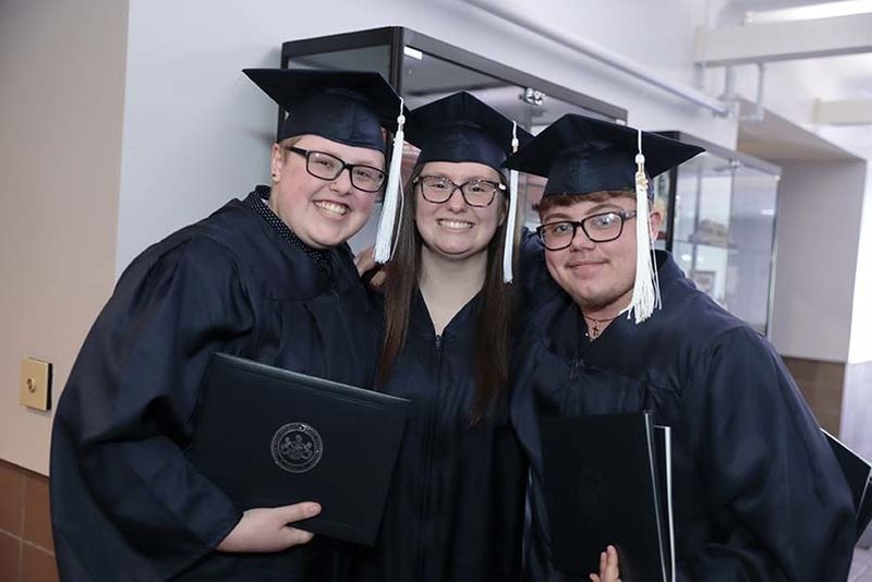 Three graduates standing together