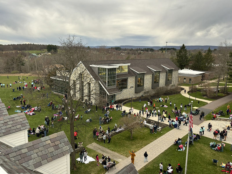 An aerial view of the campus lawn crowded with people.