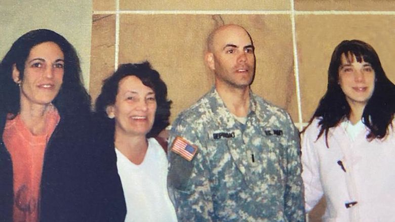 Soldier standing with three family members