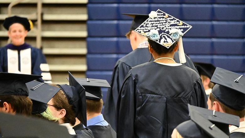 A close-up of graduates' caps as they walk to the stage.