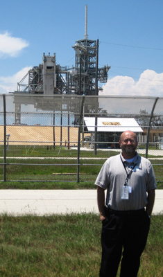 Dr. Albert Lozano standing near Launch Complex 39A