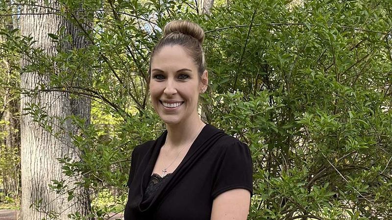 A Penn State Wilkes-Barre alumna standing outside