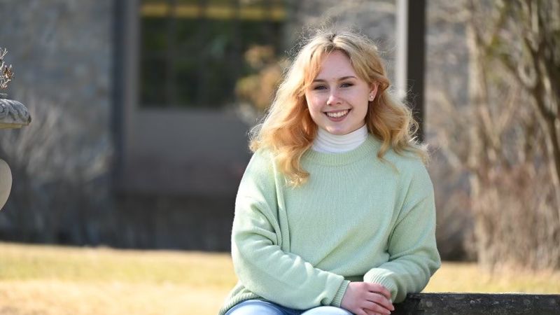 Hailey Carey sitting on a bench