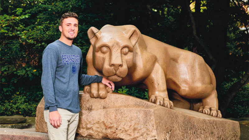 Sean-Paul Williamson at the Nittany Lion statue at University Park