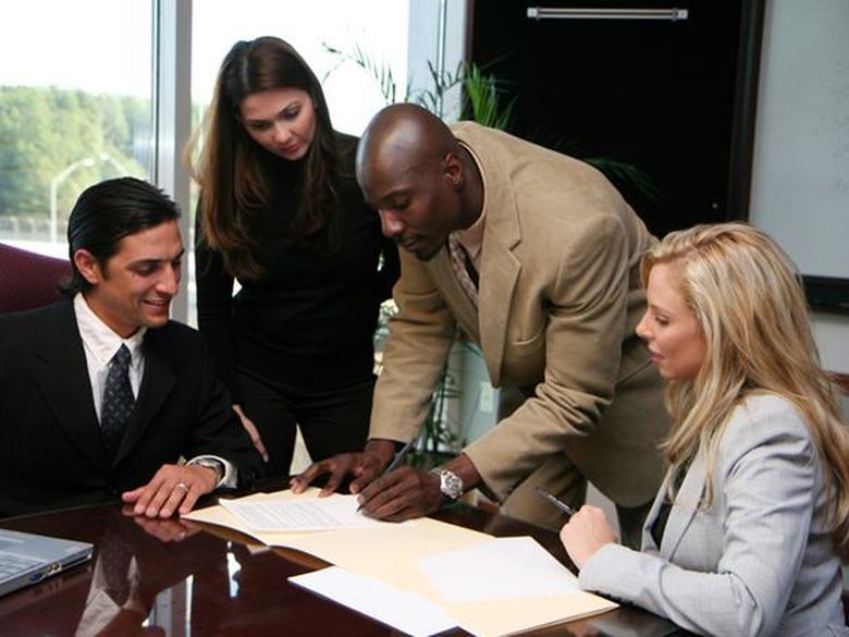 A group of business associates working around a table