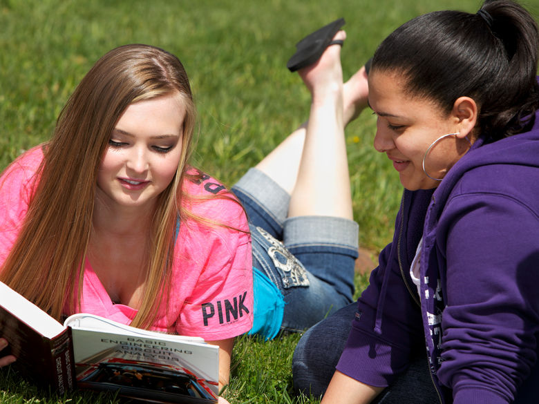 Two students studying and enjoying the outdoors