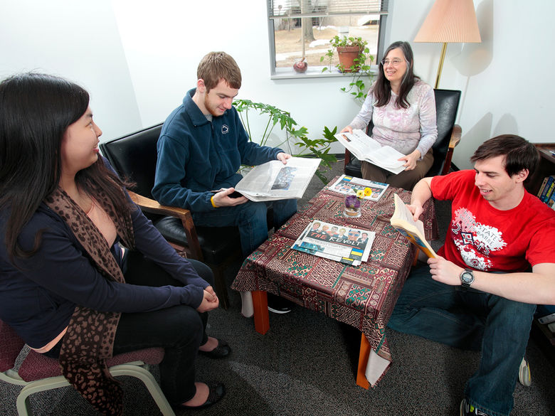 Students in the Learning Center discussing a writing assignment with a staff member