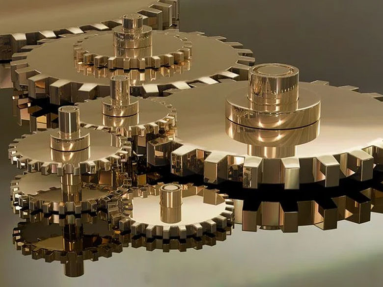 a bunch of interconnected shiny brass gears