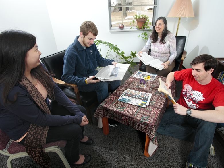 A small group of students meeting with a staff member in the Student Success Services office