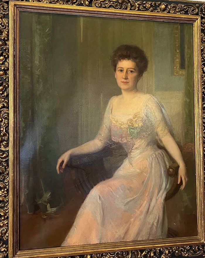 A large portrait of a seated woman.