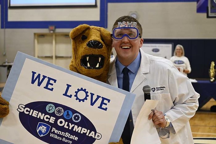 The Nittany Lion posing with a man serving as host of the event.