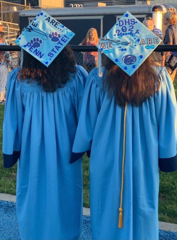 Alyssa and Kayla Hopple in their caps and gowns at their high school graduation