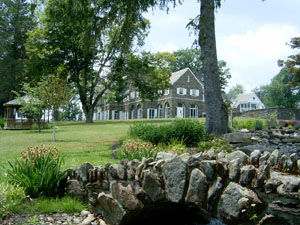 The Rave Family Pond with Hayfield House in the distance across a field