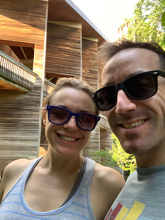 A selfie of a woman on the left and a man on the right, both wearing sunglasses.