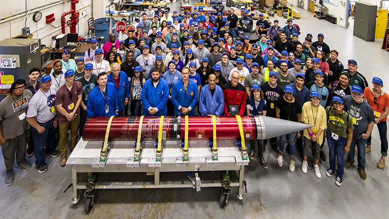 Large group of participants with their completed rocket in the front