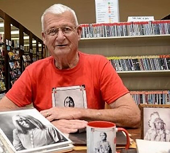 Royal Sutton displaying photos taken by Frank Rinehart