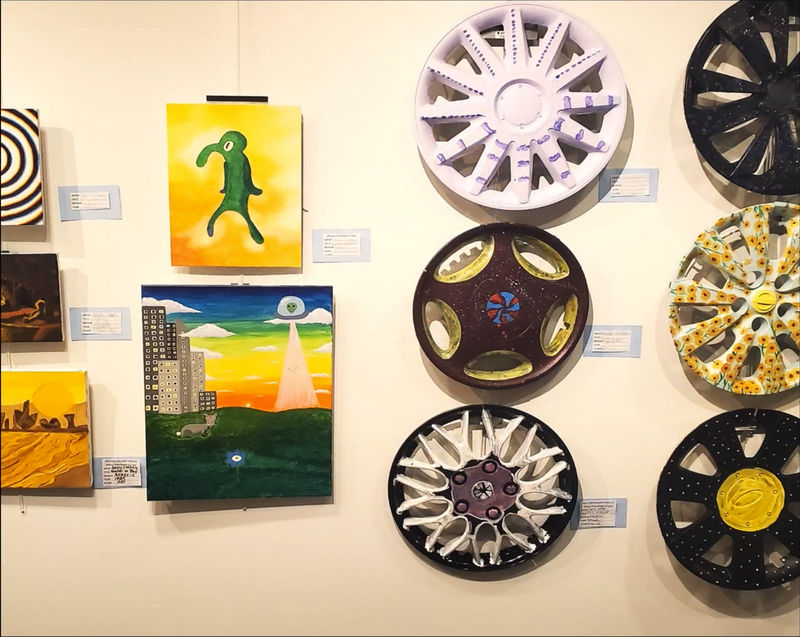 recycled hubcap art and paintings