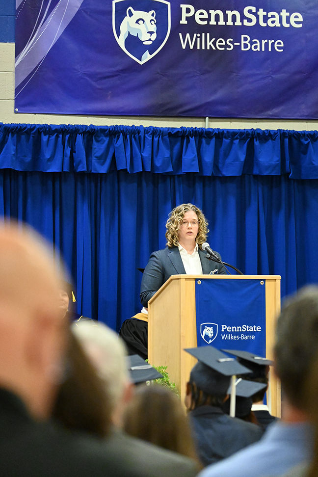 A woman speaking from the podium.