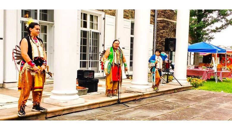 A group of Native American performers on the steps of Hayfield House.