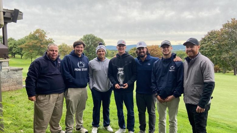 Group photo of golf team standing outdoors