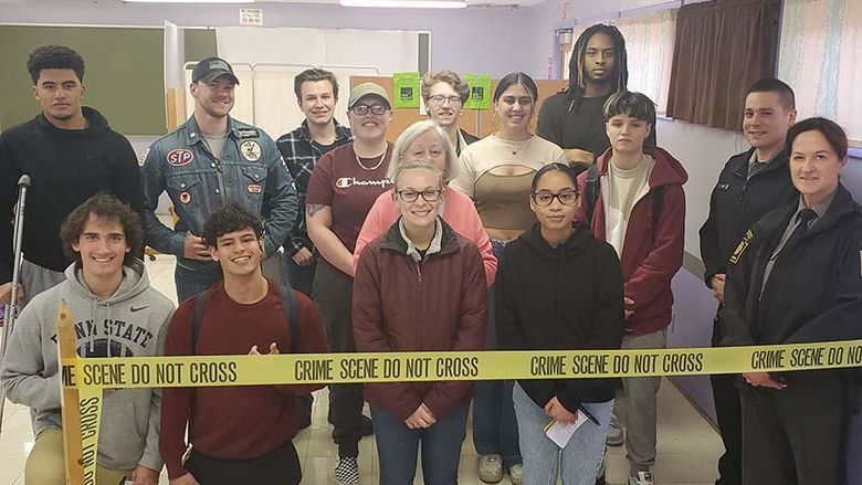 A group of people standing with crime scene tape