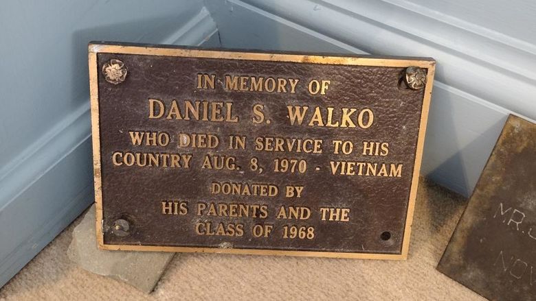 A plaque in memory of fallen servicemember Daniel S. Walko rests on the ground.