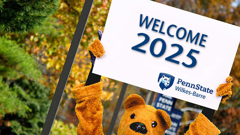 Nittany Lion mascot holding a sign over his head that says "Welcome 2025"