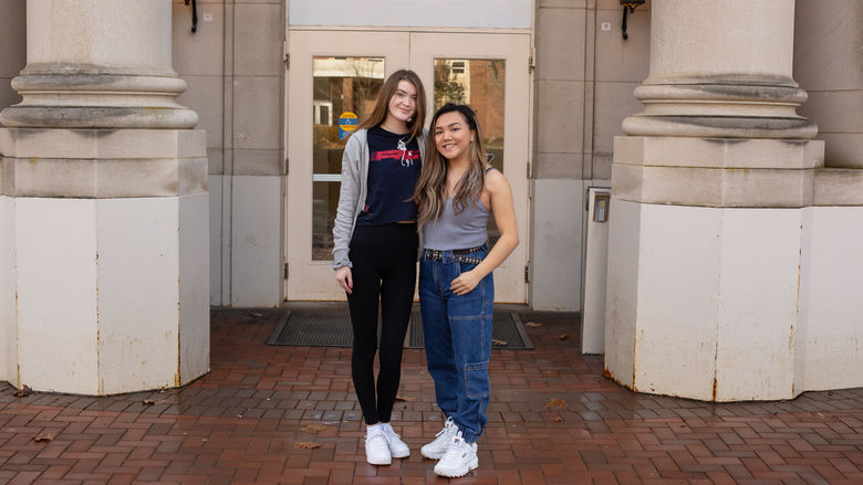 Jacqueline Siry and Megan Tam in front of the Borland Building on Campus.