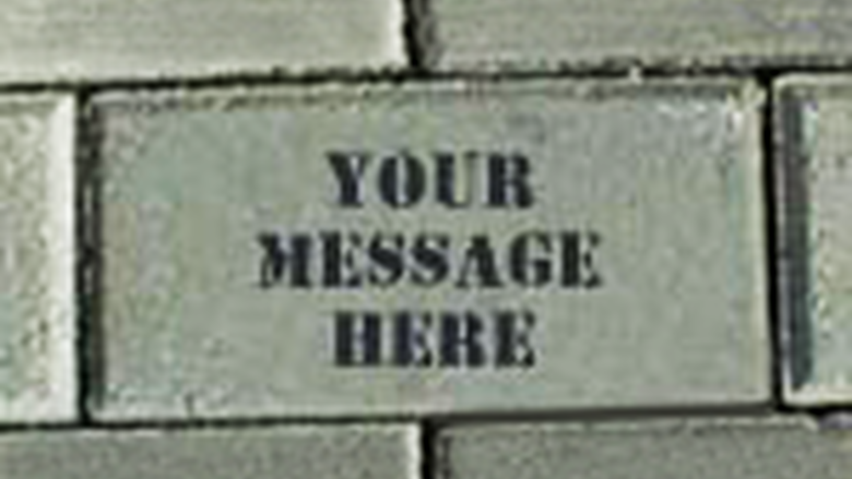 A pathway brick with "Your Message Here" printed on it