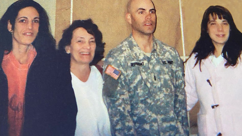 Soldier standing with three family members