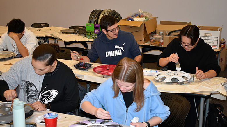Students making art with hubcaps