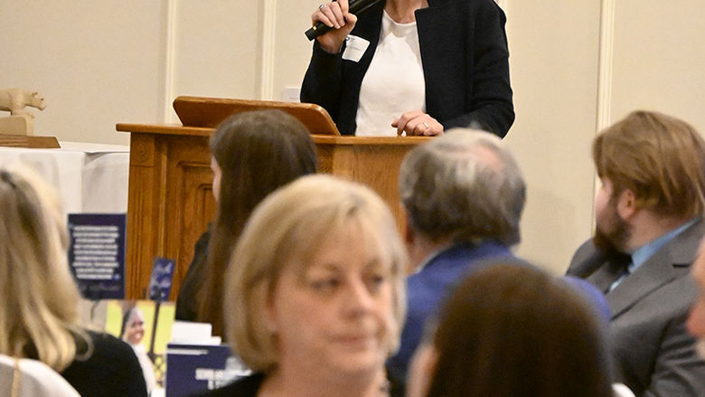 A woman speaking at the podium