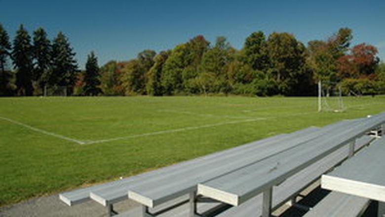 The athletic fields on a sunny day, with aluminum bleachers in the foreground