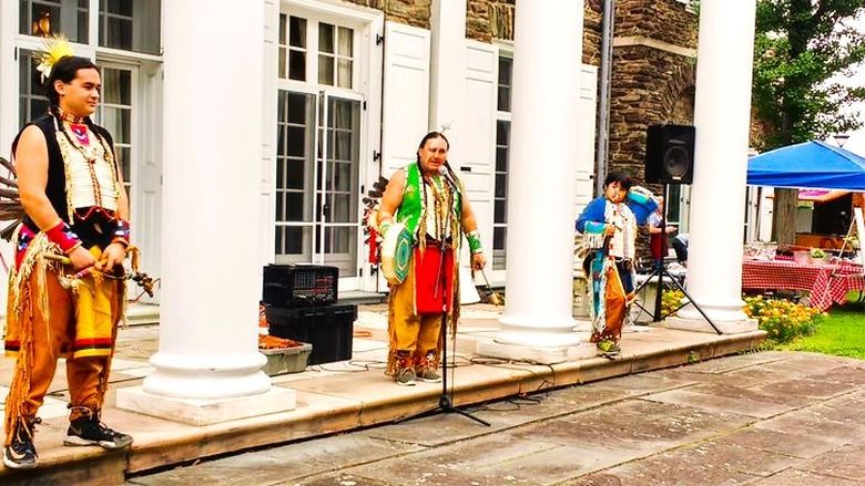 A group of performers in front of Hayfield House