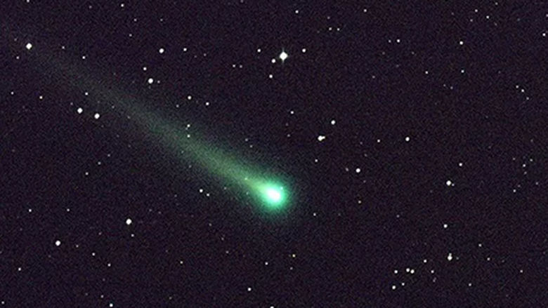 The night sky with the green comet and a background of stars