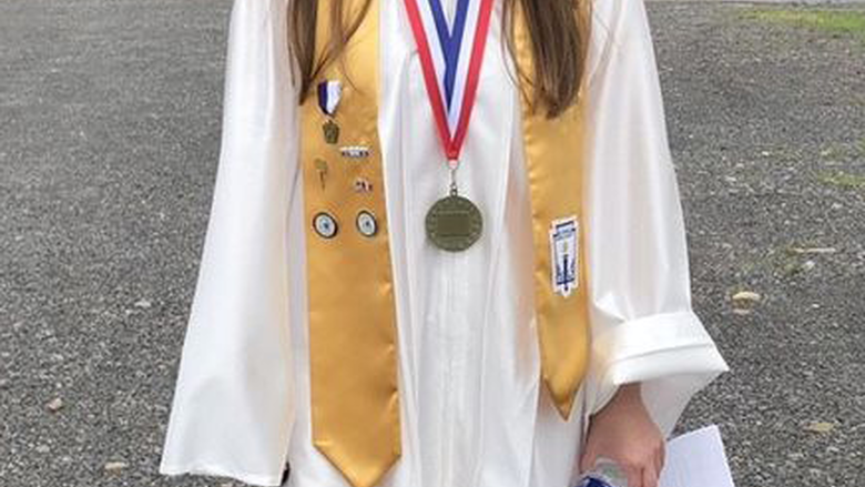 Hannah Farber in white graduation robes
