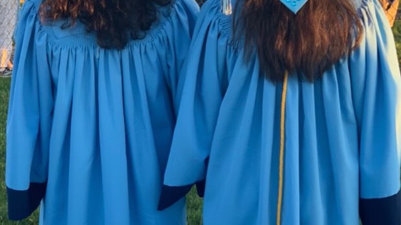 Alyssa and Kayla Hopple in their caps and gowns at their high school graduation