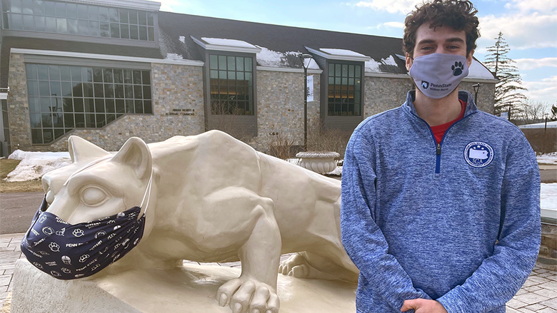 Student Government Association President Larry Corridoni stands in front of the Nittany lion shrine at Penn State Wilkes-Barre.