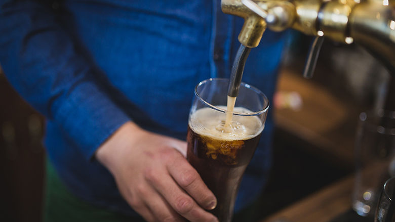 Beer Being Poured From A Tap