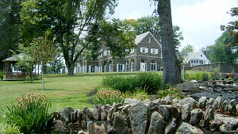 The Rave Family Pond with Hayfield House in the distance across a field