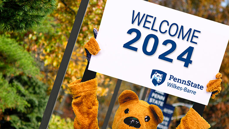Nittany Lion Mascot holding a sign saying, "Welcome 2024"