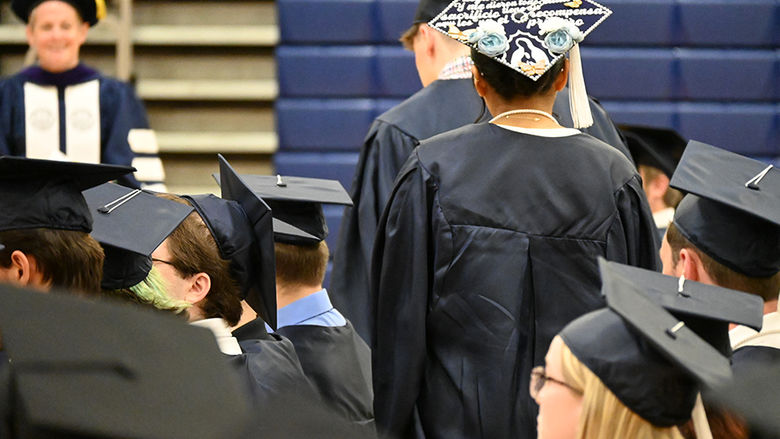 A close-up of graduates' caps as they walk to the stage.