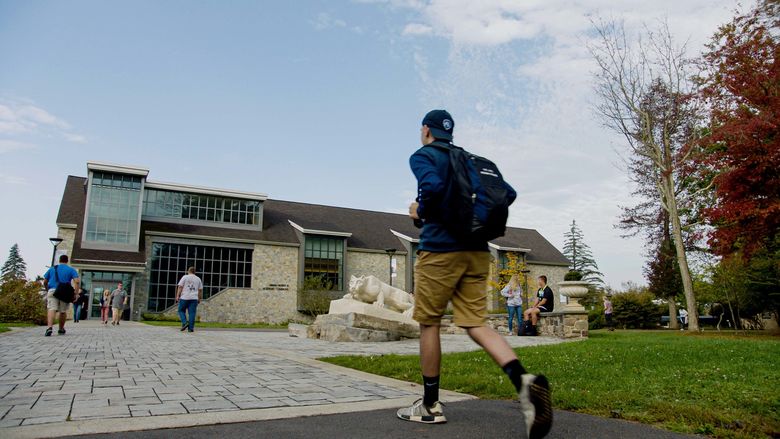Student walking toward a campus building