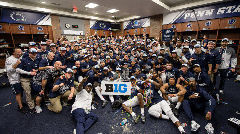 Football team poses in locker room after 2016 Big Ten title game