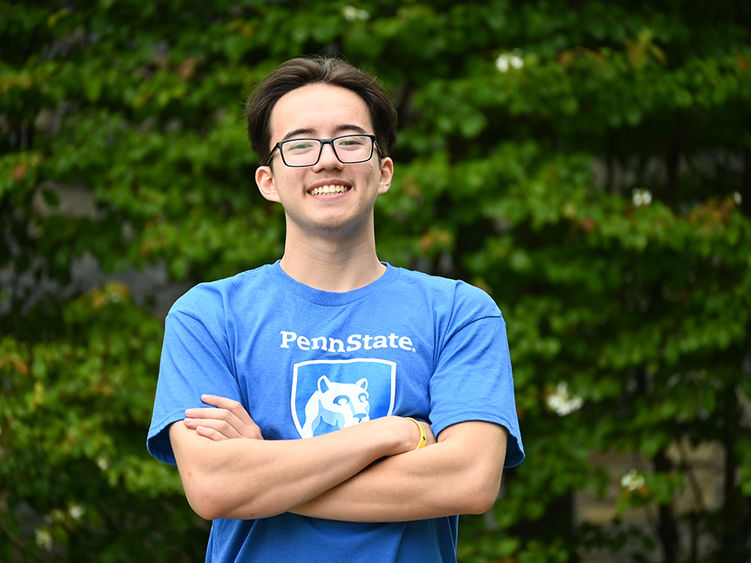 A man in glasses wearing a blue T-shirt with the Penn State logo and the words "Penn State Wilkes-Barre" standing with his arms crossed.