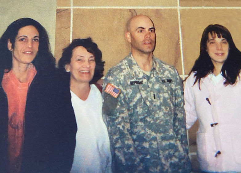 Soldier standing with three family members