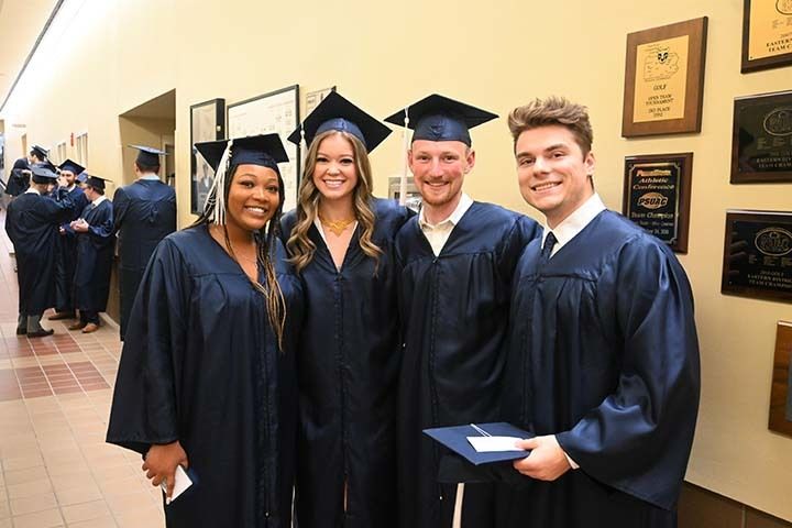 Four graduates standing together