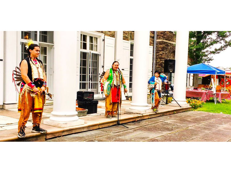A group of Native American performers on the steps of Hayfield House.