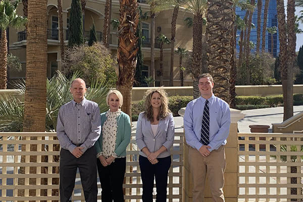 A group photo of three faculty members and one student