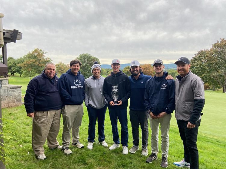 Group photo of golf team standing outdoors